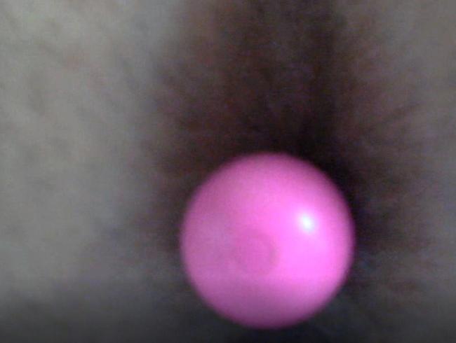 zoom on a small pink vibrator which I put in a hole in the ass